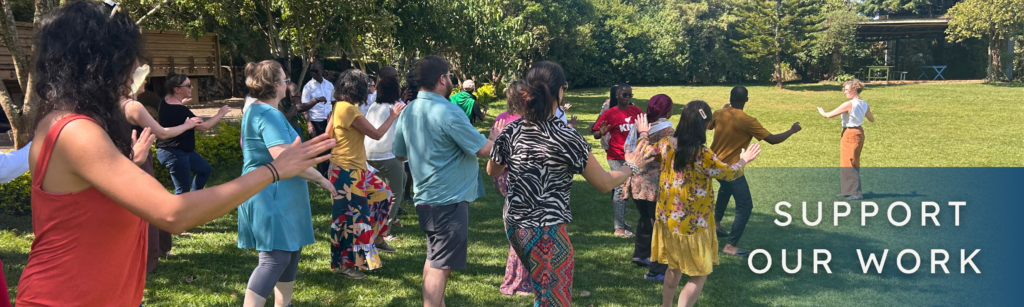 A group of people doing a dance pose on the grass